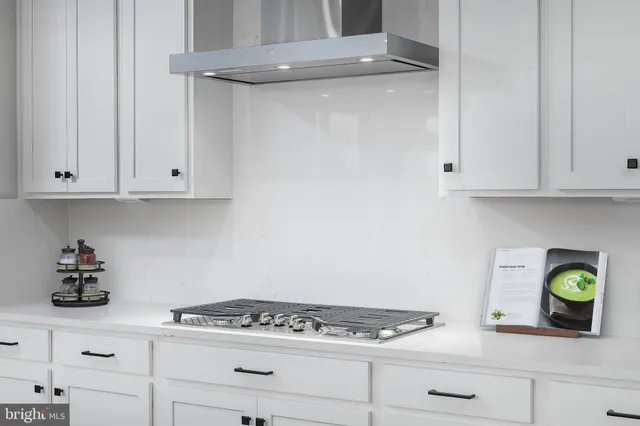 a kitchen with white cabinets and appliances