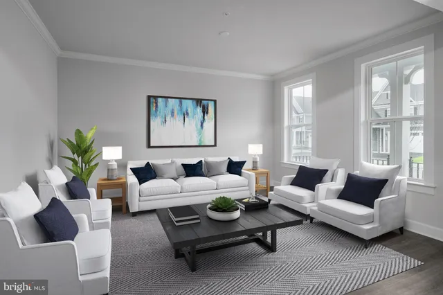 a living room with furniture potted plant and window
