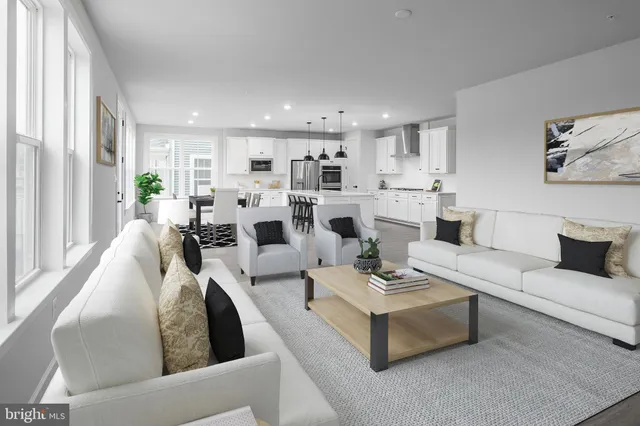 a living room with fireplace furniture and a large window