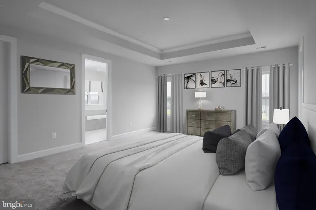 a bedroom with a bed and a large mirror