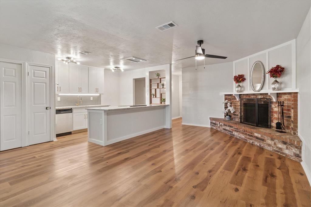 511 Cumberland Drive Allen, TX 75002 - Photo 1 of 1 a view of a kitchen with wooden floor and a fireplace