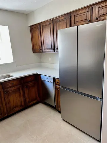 a kitchen with cabinets and stainless steel appliances