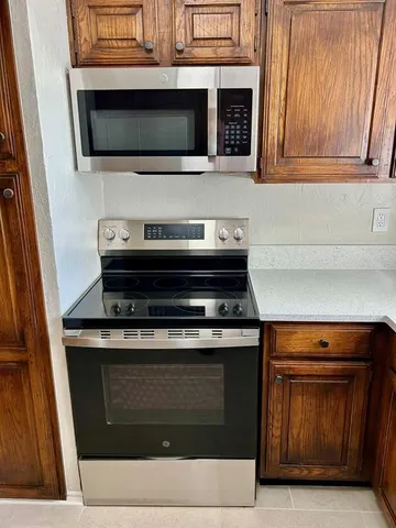 a stove top oven sitting inside of a kitchen