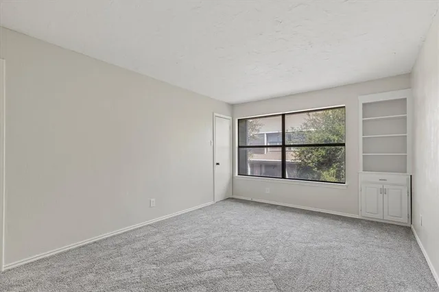 an empty room with a empty space and windows