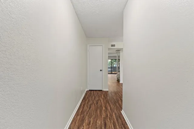 a view of a room with wooden floor