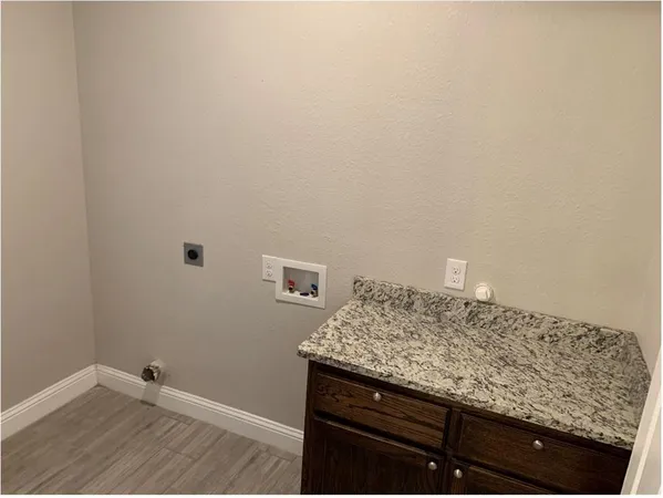 a view of bathroom with granite countertop cabinets and sink