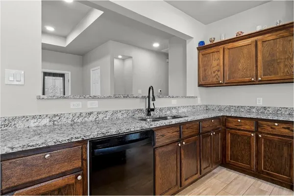 a kitchen with stainless steel appliances granite countertop a sink and cabinets