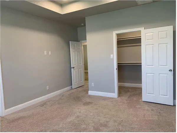 a view of an empty room and closet area