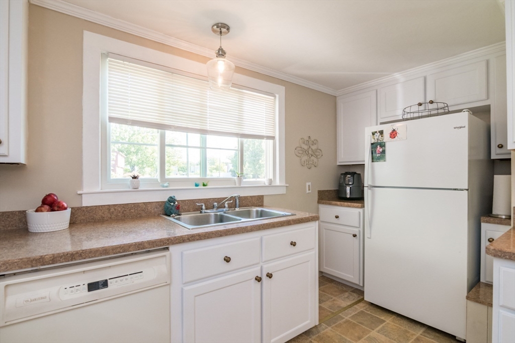 20 Dunton Street Montague, MA 01376 - Photo 11 of 36 a kitchen with refrigerator a sink a bed and cabinets