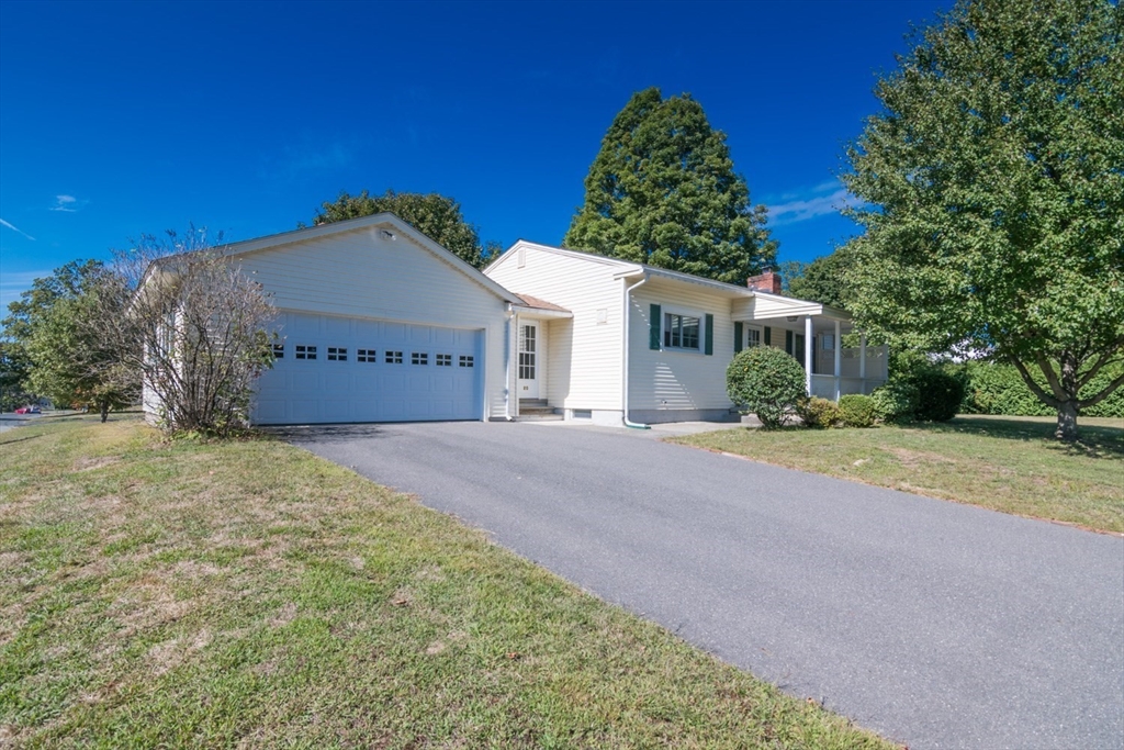 20 Dunton Street Montague, MA 01376 - Photo 2 of 36 a front view of a house with a yard and garage