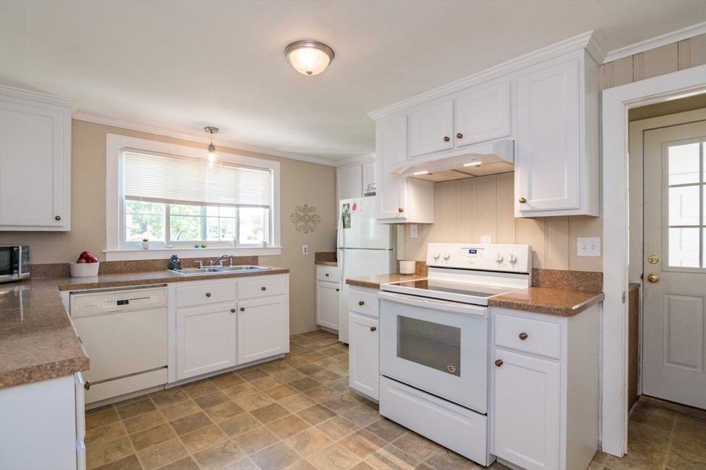 20 Dunton Street Montague, MA 01376 - Photo 8 of 36 a kitchen with granite countertop white cabinets and white appliances