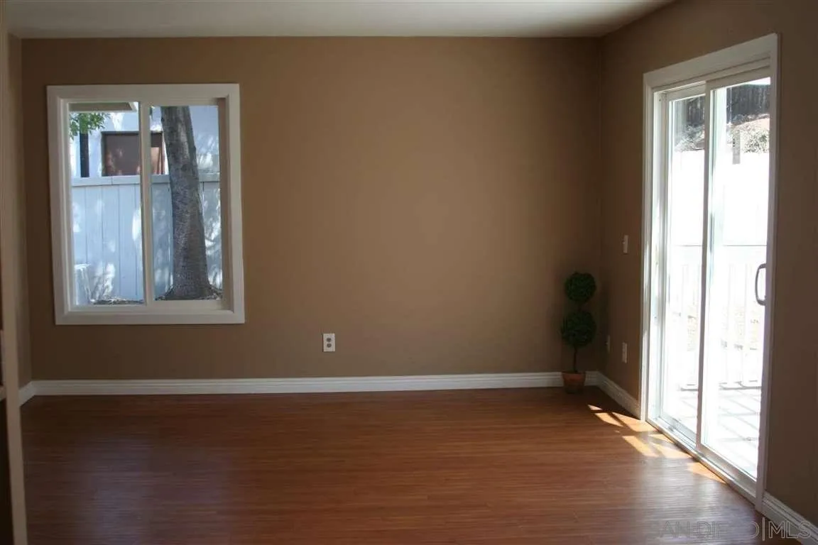 13605 Acton Avenue Poway, CA 92064 - Photo 11 of 18 a view of an empty room with wooden floor and a window