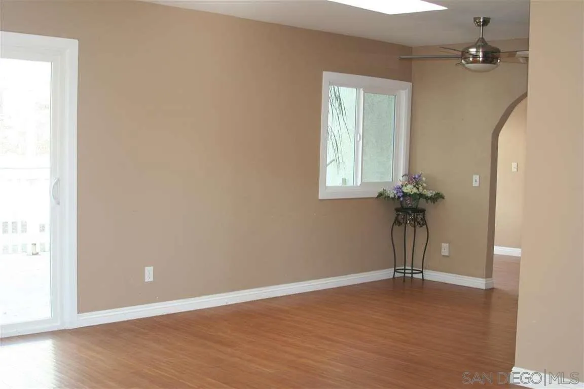 13605 Acton Avenue Poway, CA 92064 - Photo 3 of 18 an empty room with a door and windows