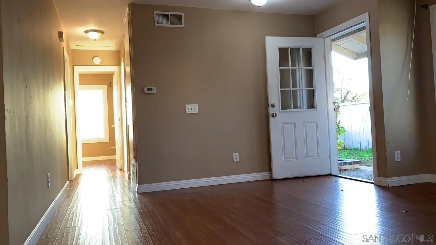 13605 Acton Avenue Poway, CA 92064 - Photo 4 of 18 a view of a hallway with wooden floor and windows