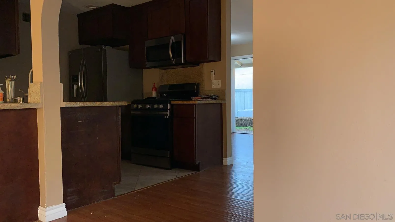 13605 Acton Avenue Poway, CA 92064 - Photo 8 of 18 a kitchen with a refrigerator and a stove top oven