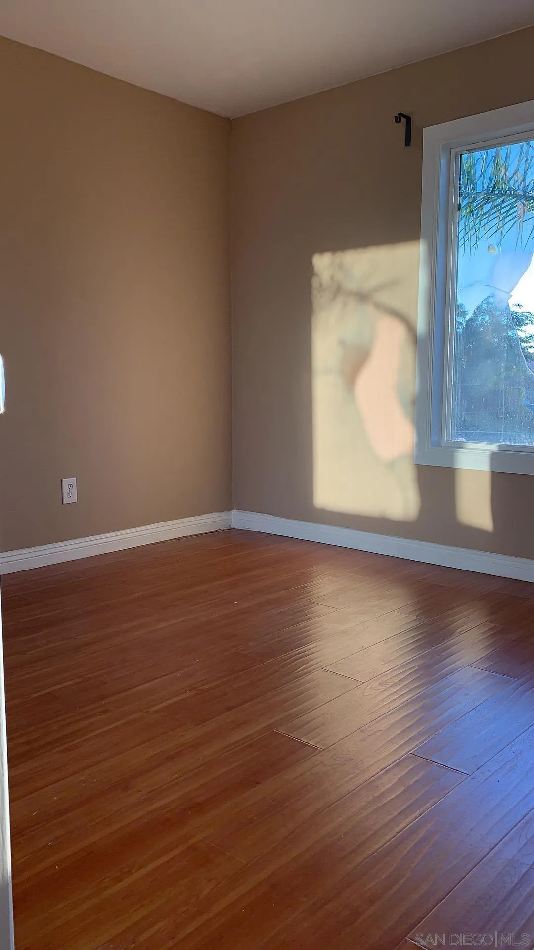 13605 Acton Avenue Poway, CA 92064 - Photo 10 of 18 a view of room with window and wooden floor