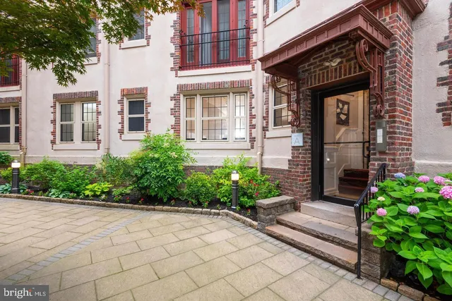 a view of a house with potted plants