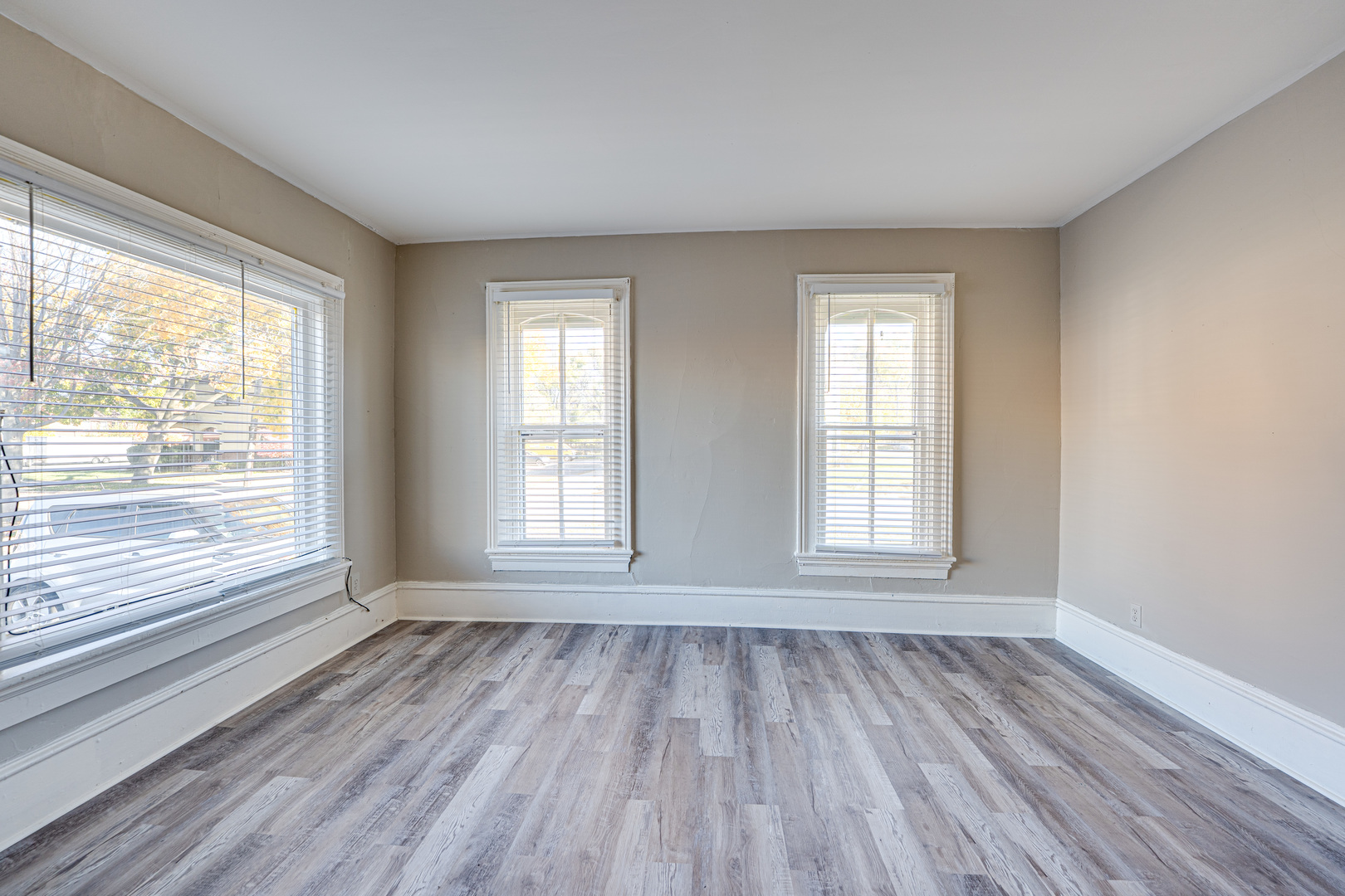 79 South 4th Street, Unit 2 Aurora, IL 60505 - Photo 6 of 10 a view of an empty room with wooden floor and a window