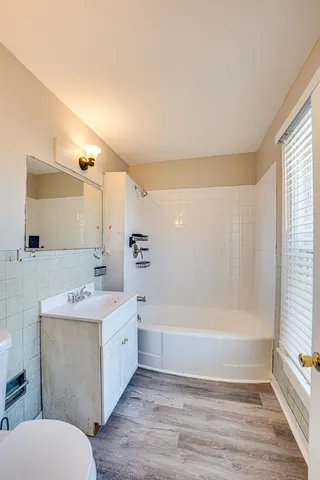 a bathroom with a sink mirror toilet and bathtub