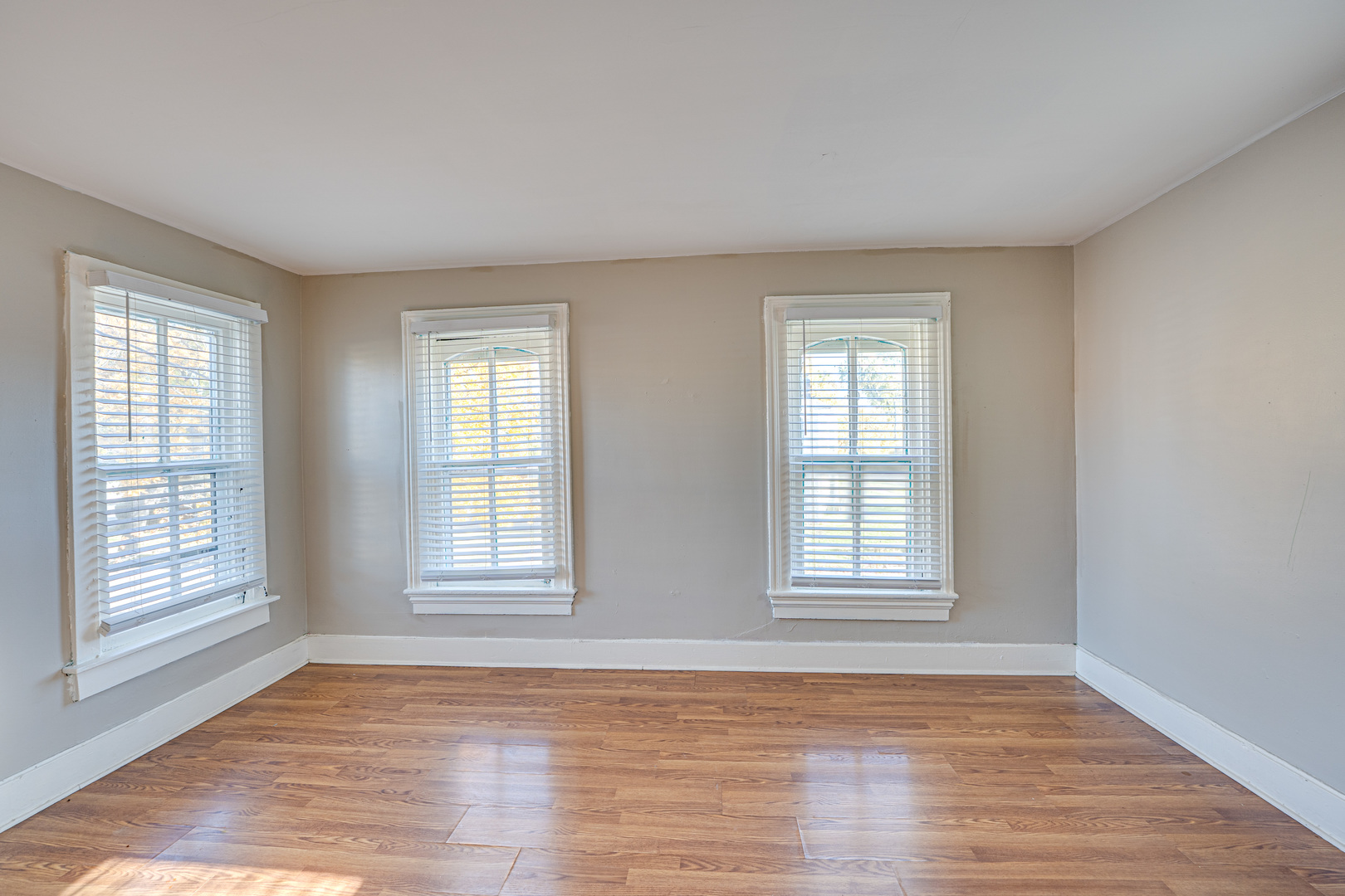 79 South 4th Street, Unit 2 Aurora, IL 60505 - Photo 8 of 10 a view of an empty room with wooden floor and window