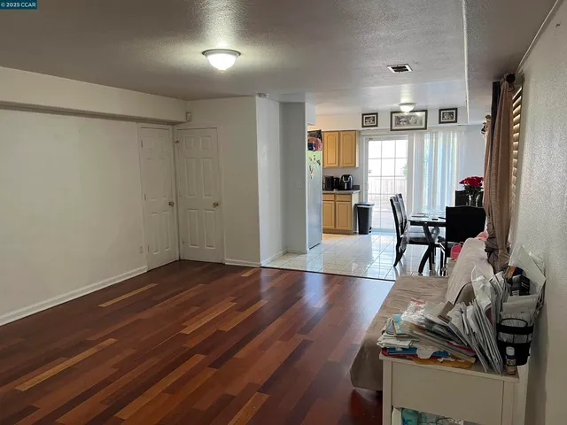 a view of a room with furniture and wooden floor