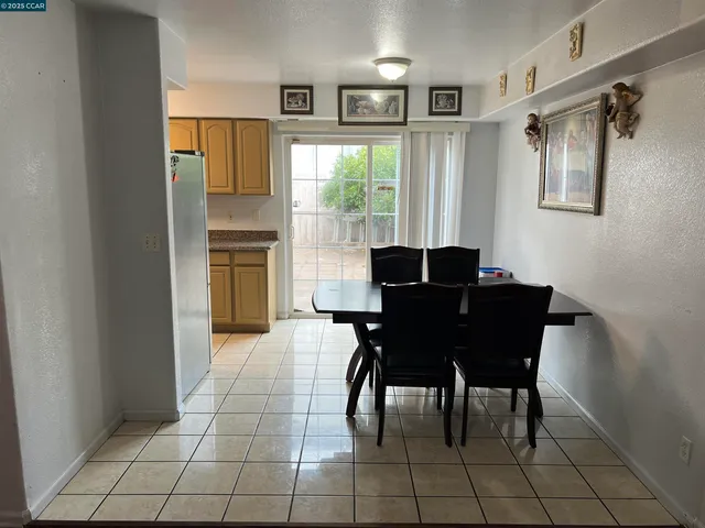 a view of a dining room with furniture and a window