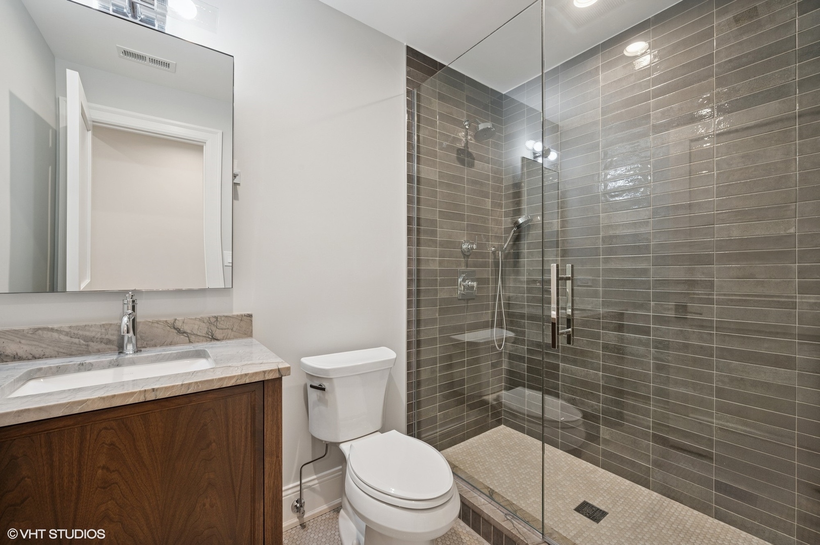 1171 Hohlfelder Road Glencoe, IL 60022 - Photo 30 of 56 a bathroom with a sink a toilet and shower