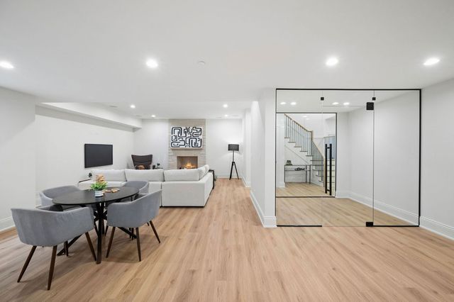 a view of a big room with wooden floor and stairs