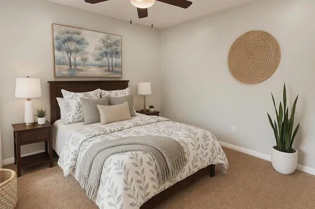 a bedroom with a bed and a painting on the wall