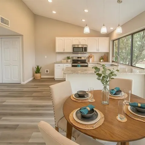 a kitchen with a table and chairs