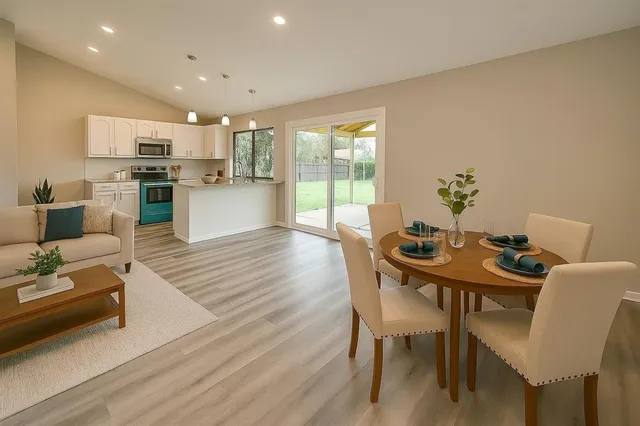 a view of a dining room with furniture and wooden floor