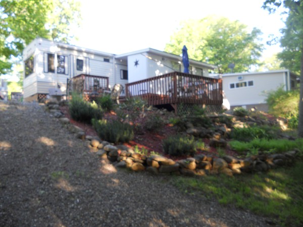 8 S Road, Unit R73 Stafford, CT 06076 - Photo 3 of 28 a view of a house with a yard and plants