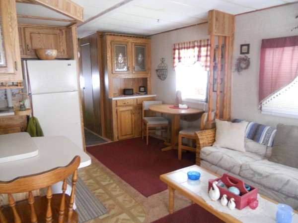8 S Road, Unit R73 Stafford, CT 06076 - Photo 8 of 28 a living room with furniture a dining table and a refrigerator