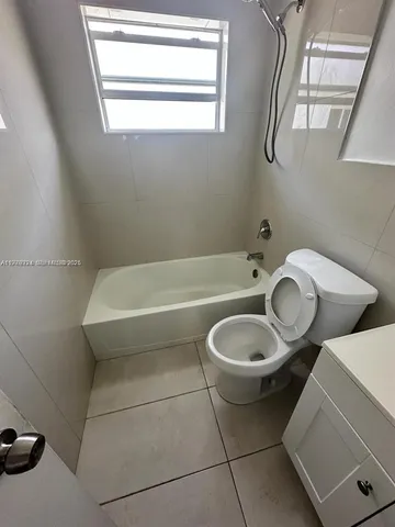 a bathroom with a toilet and a bathtub