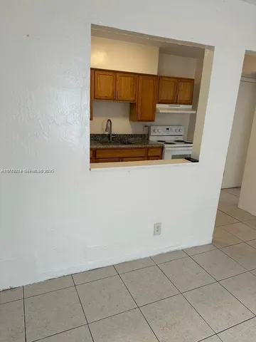 a kitchen with stainless steel appliances a sink and a microwave