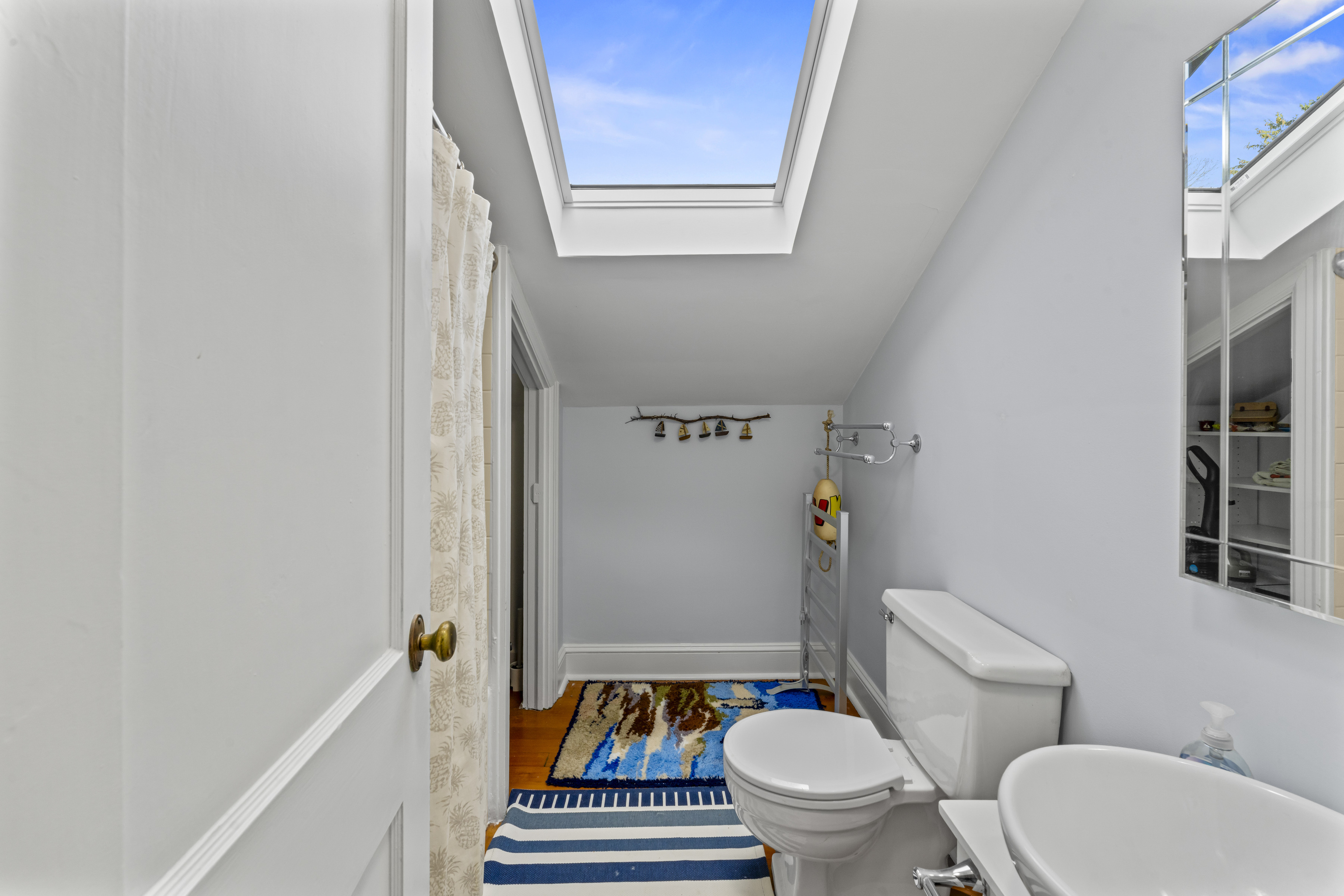 3 Topside Lane Newtown, CT 06470 - Photo 32 of 38 a white toilet sitting next to a bathroom sink and a mirror