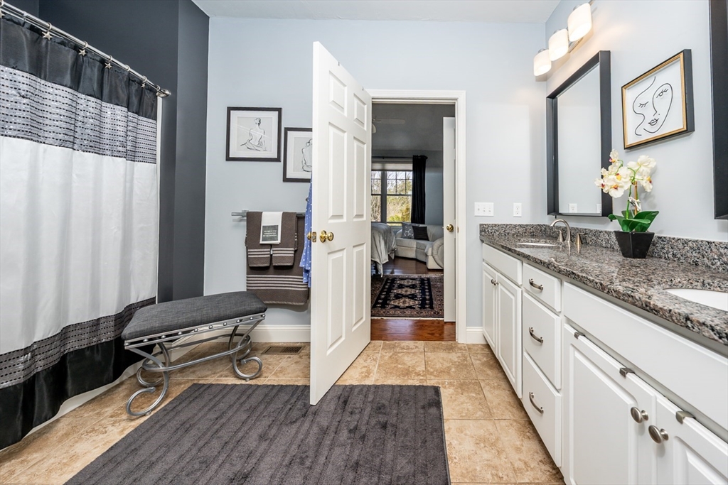 27 Grey Hawk Drive, Unit 628 Mashpee, MA 02649 - Photo 12 of 40 a kitchen with granite countertop a refrigerator and a sink