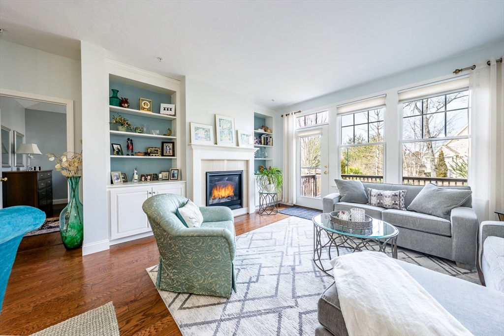 27 Grey Hawk Drive, Unit 628 Mashpee, MA 02649 - Photo 7 of 40 a living room with furniture and a fireplace
