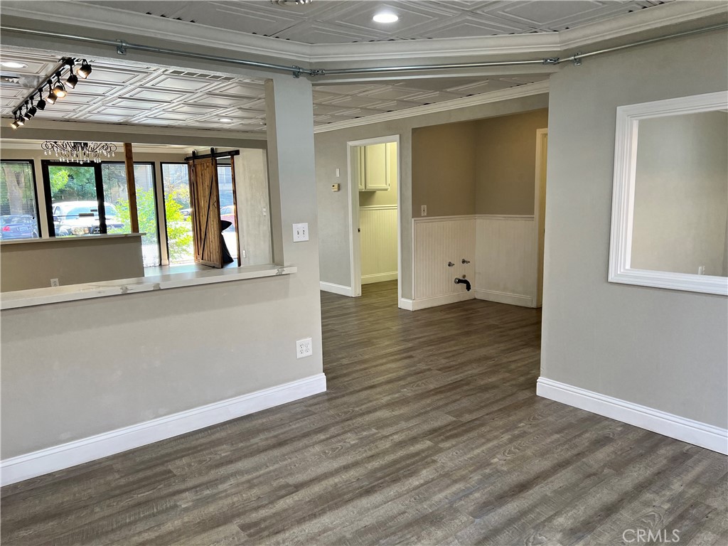 840 West Olive Avenue, Unit C Merced, CA 95348 - Photo 12 of 26 wooden floor in an empty room with a window