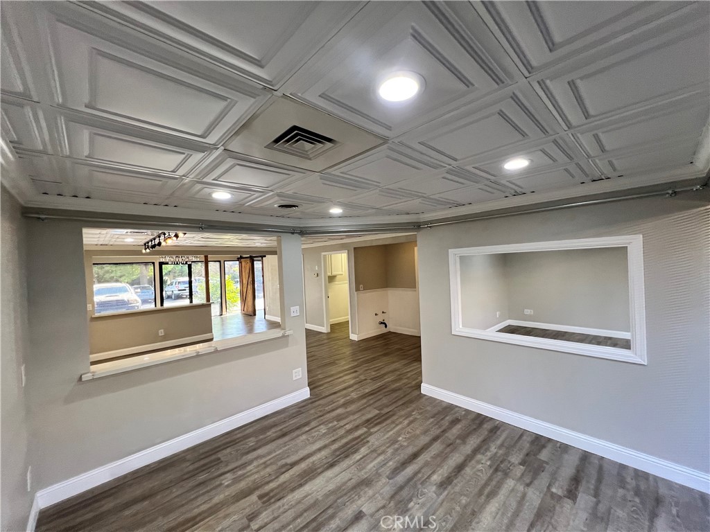 840 West Olive Avenue, Unit C Merced, CA 95348 - Photo 13 of 26 a view of empty room with wooden floor and fan