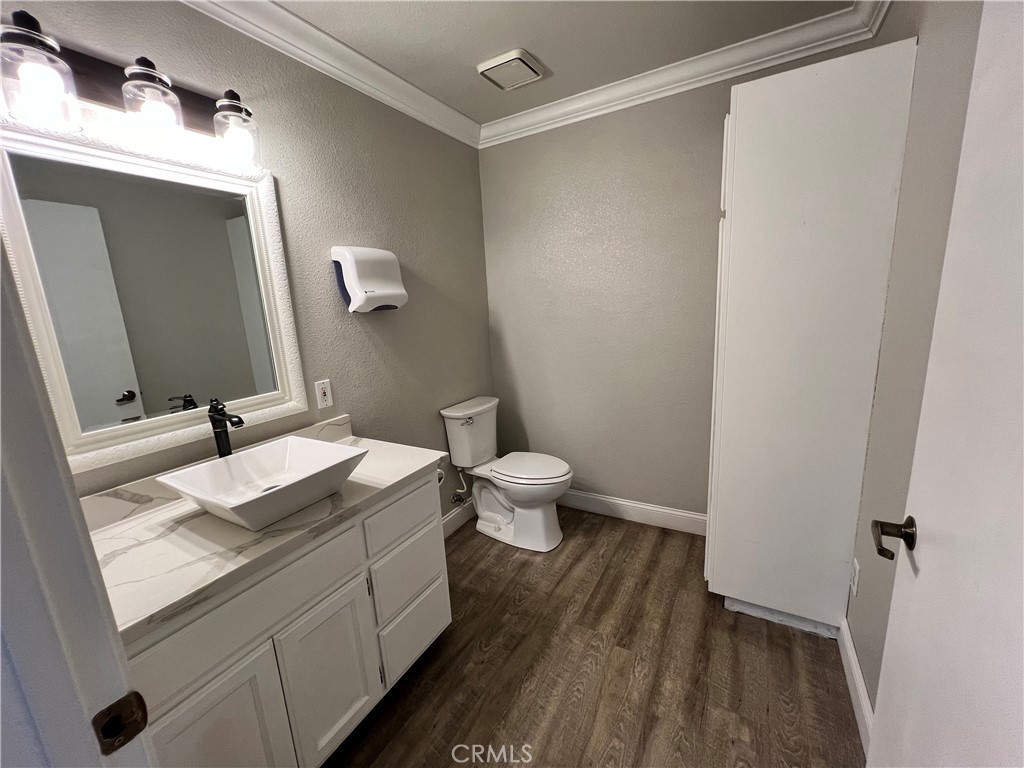840 West Olive Avenue, Unit C Merced, CA 95348 - Photo 17 of 26 a bathroom with a granite countertop sink mirror vanity and toilet