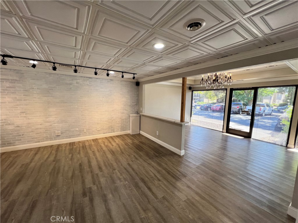 840 West Olive Avenue, Unit C Merced, CA 95348 - Photo 4 of 26 an empty room with wooden floor and windows
