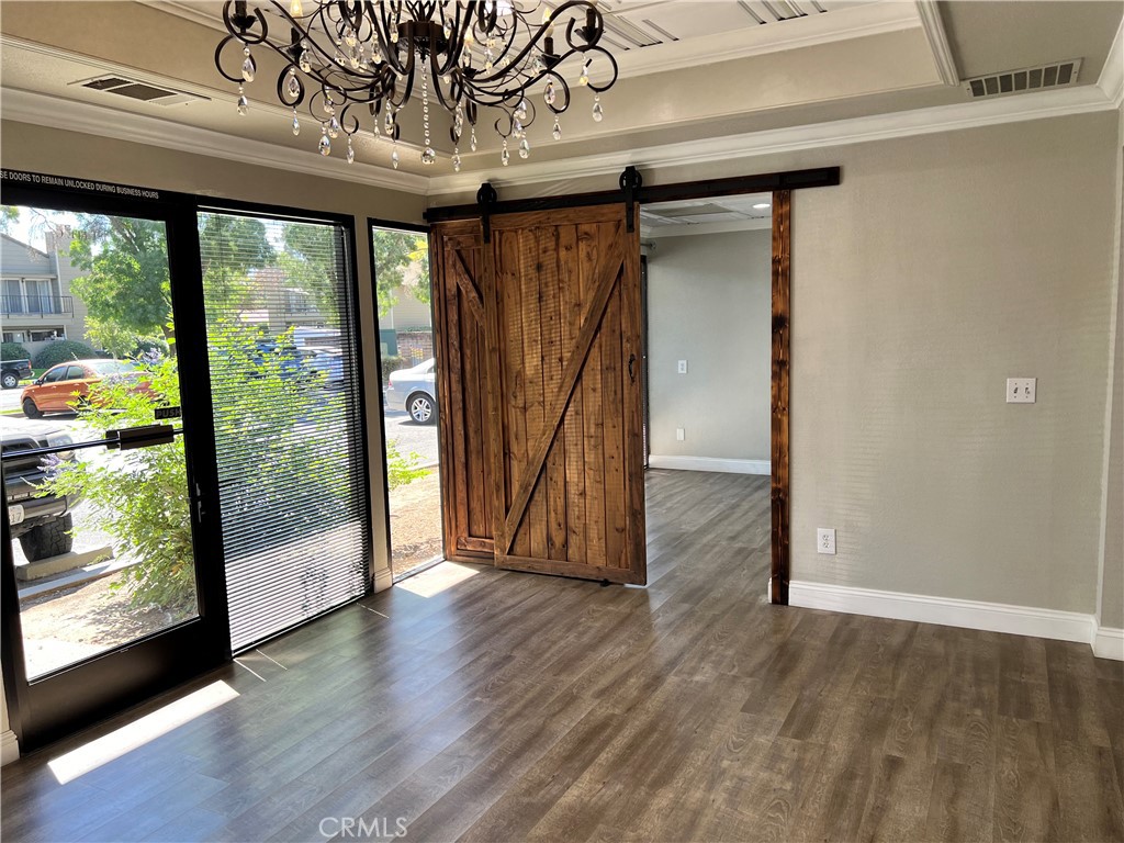 840 West Olive Avenue, Unit C Merced, CA 95348 - Photo 5 of 26 an empty room with wooden floor and door