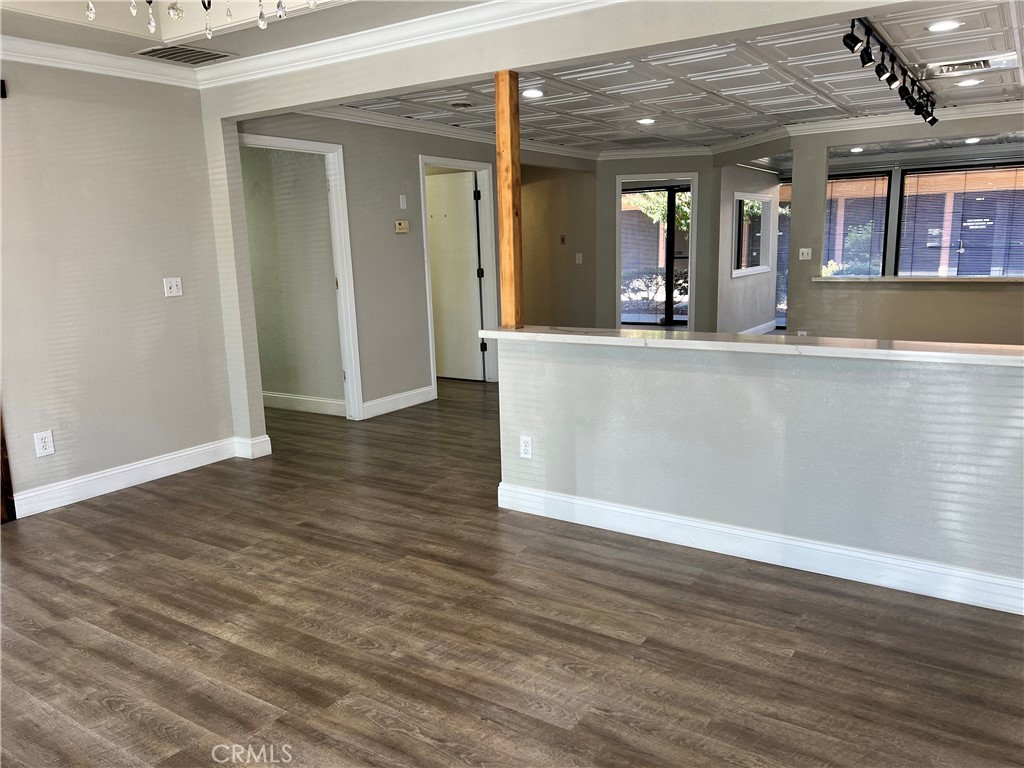 840 West Olive Avenue, Unit C Merced, CA 95348 - Photo 7 of 26 wooden floor in a room with kitchen view and wooden floor