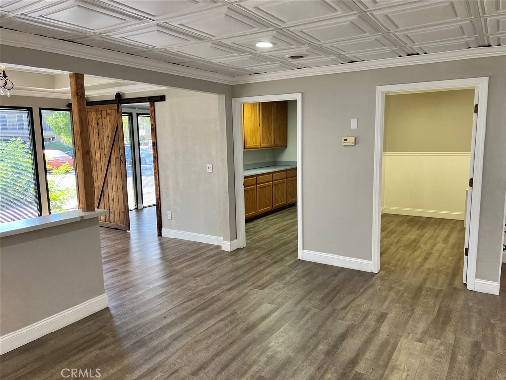 840 West Olive Avenue, Unit C Merced, CA 95348 - Photo 8 of 26 wooden floor in an empty room with a window