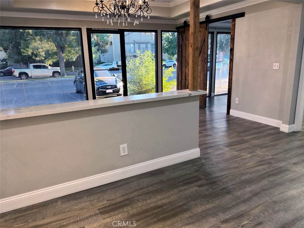 840 West Olive Avenue, Unit C Merced, CA 95348 - Photo 9 of 26 wooden floor in an empty room with a window