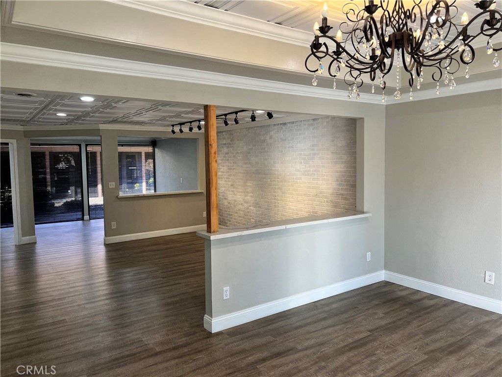 840 West Olive Avenue, Unit C Merced, CA 95348 - Photo 10 of 26 an empty room with wooden floor and windows