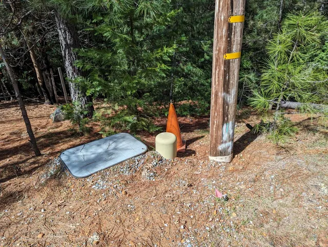 a backyard of a house with table and chairs a barbeque with potted plants
