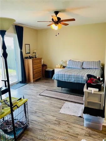 a bedroom with a bed and wooden floor