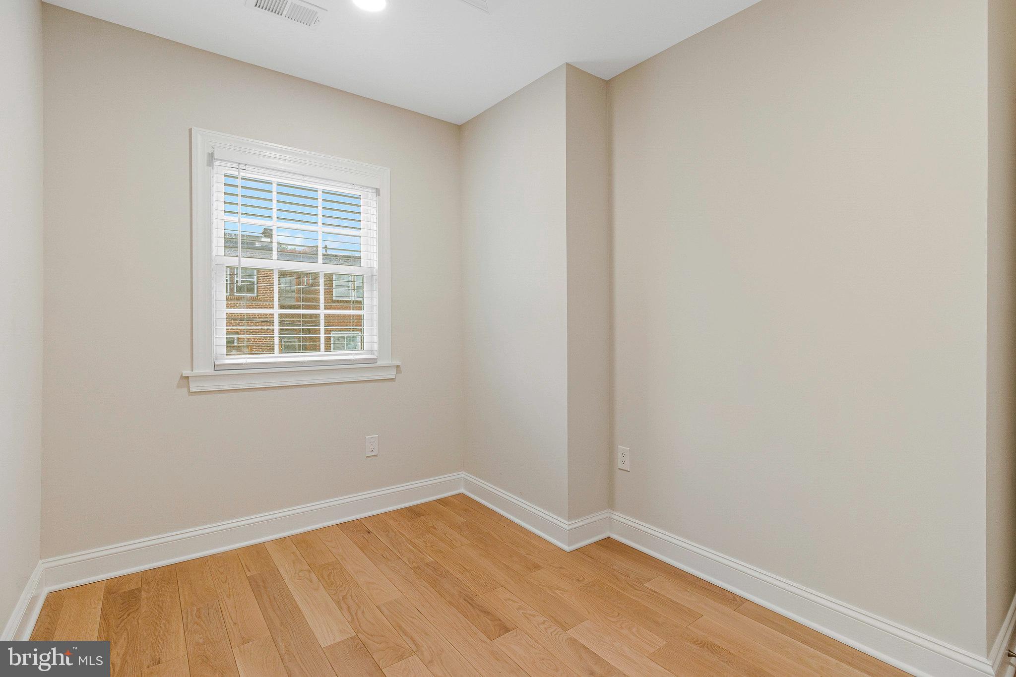 1350 Sheridan Street Northwest Washington, DC 20011 - Photo 24 of 55 a view of an empty room with wooden floor and a window